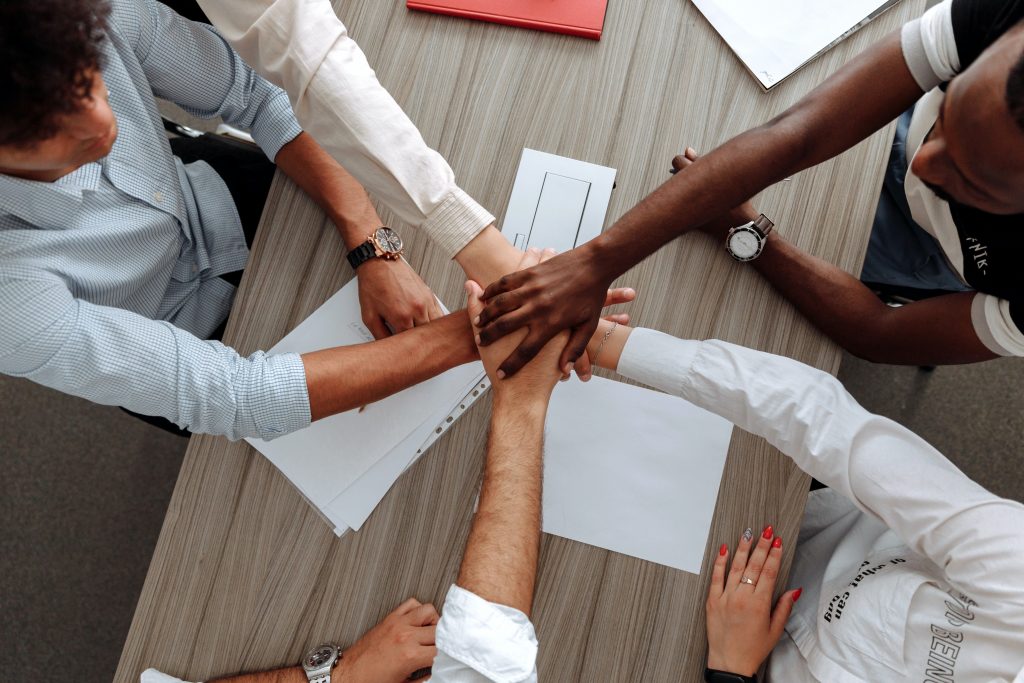 High 5 with a number of hands. The Professional Man Magazine.