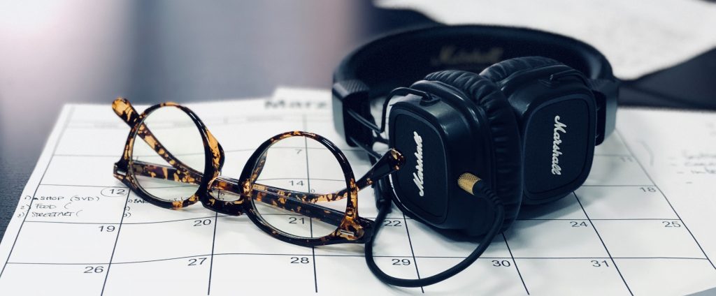 glasses and headphones on a calendar