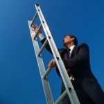 businessman climbing the corporate ladder