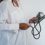 doctor holding blood pressure device
