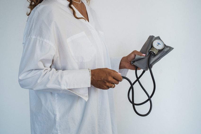 doctor holding blood pressure device
